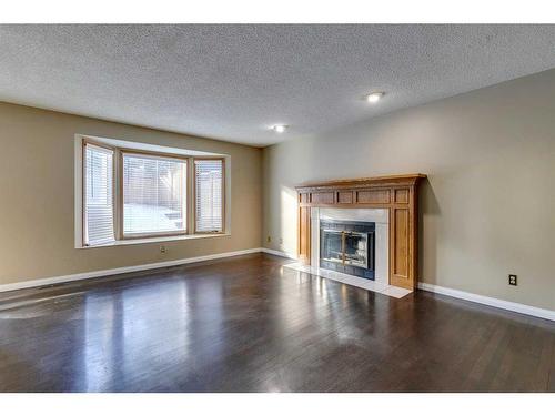 53 Shawnee Rise Sw, Calgary, AB - Indoor Photo Showing Living Room With Fireplace