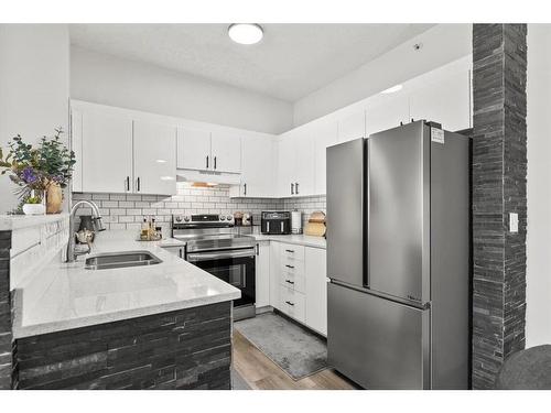 1415-1140 Taradale Drive Ne, Calgary, AB - Indoor Photo Showing Kitchen With Stainless Steel Kitchen With Double Sink