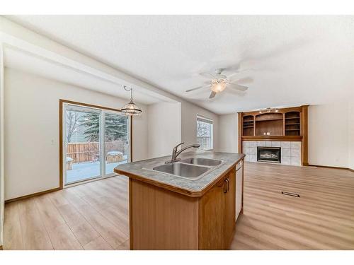 221 Mt Douglas Circle Se, Calgary, AB - Indoor Photo Showing Kitchen With Fireplace With Double Sink