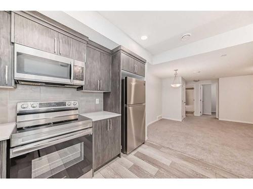 144 Lucas Street Nw, Calgary, AB - Indoor Photo Showing Kitchen With Stainless Steel Kitchen