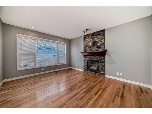 183 Hillcrest Circle Sw, Airdrie, AB - Indoor Photo Showing Living Room With Fireplace