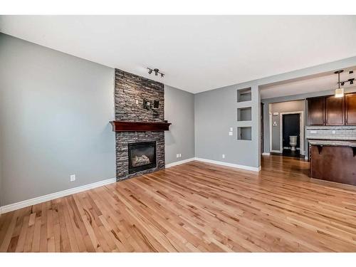 183 Hillcrest Circle Sw, Airdrie, AB - Indoor Photo Showing Living Room With Fireplace