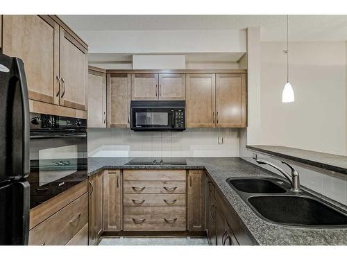 453-26 Val Gardena View Sw, Calgary, AB - Indoor Photo Showing Kitchen With Double Sink