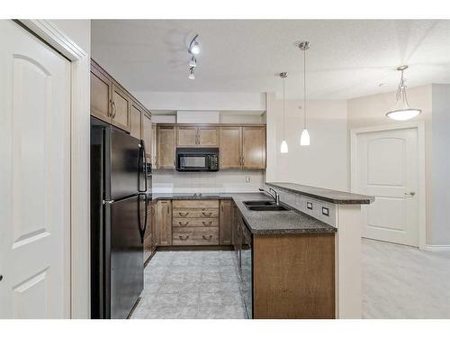 453-26 Val Gardena View Sw, Calgary, AB - Indoor Photo Showing Kitchen With Double Sink