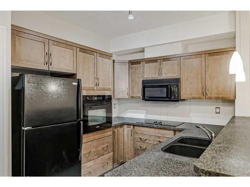 453-26 Val Gardena View Sw, Calgary, AB - Indoor Photo Showing Kitchen With Double Sink