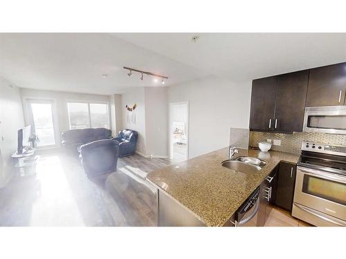 608-210 15 Avenue Se, Calgary, AB - Indoor Photo Showing Kitchen With Stainless Steel Kitchen With Double Sink