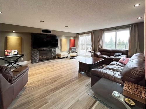 27 Calling Horse Estates, Rural Rocky View County, AB - Indoor Photo Showing Living Room With Fireplace