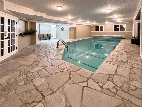 27 Calling Horse Estates, Rural Rocky View County, AB - Indoor Photo Showing Other Room With In Ground Pool