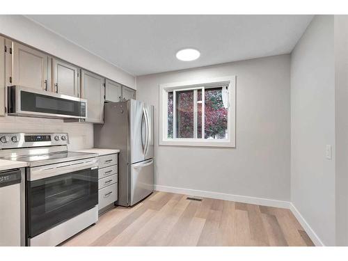 3-310 Brookmere Road Sw, Calgary, AB - Indoor Photo Showing Kitchen With Stainless Steel Kitchen