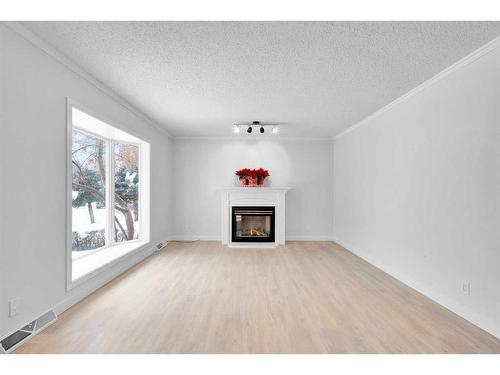 2033 Cottonwood Crescent Se, Calgary, AB - Indoor Photo Showing Living Room With Fireplace