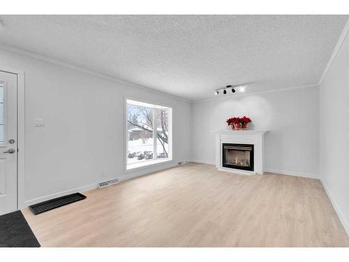 2033 Cottonwood Crescent Se, Calgary, AB - Indoor Photo Showing Living Room With Fireplace