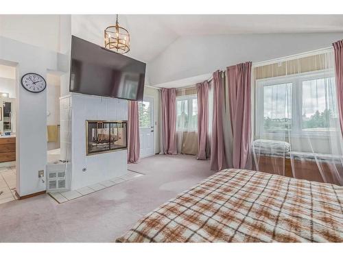 852 Shawnee Drive Sw, Calgary, AB - Indoor Photo Showing Bedroom With Fireplace