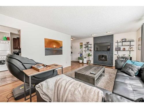 135 Carr Crescent, Okotoks, AB - Indoor Photo Showing Living Room With Fireplace