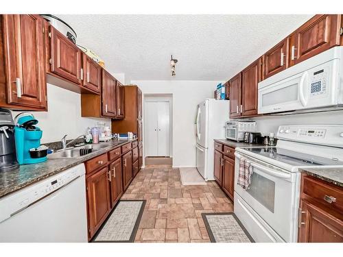 135 Carr Crescent, Okotoks, AB - Indoor Photo Showing Kitchen With Double Sink