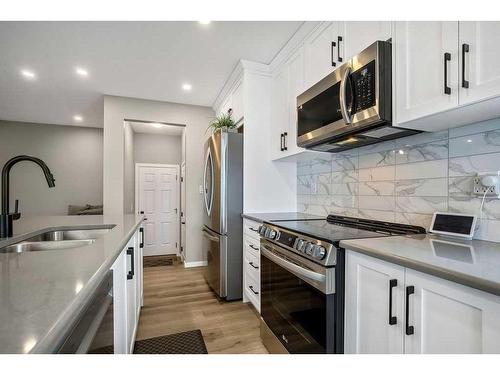 169 Yorkville Boulevard Sw, Calgary, AB - Indoor Photo Showing Kitchen With Stainless Steel Kitchen With Double Sink With Upgraded Kitchen