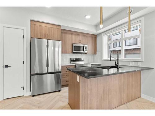 301-562 Seton Circle Se, Calgary, AB - Indoor Photo Showing Kitchen With Stainless Steel Kitchen With Double Sink