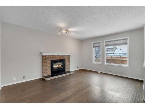 12 Riverwood Crescent Se, Calgary, AB - Indoor Photo Showing Living Room With Fireplace