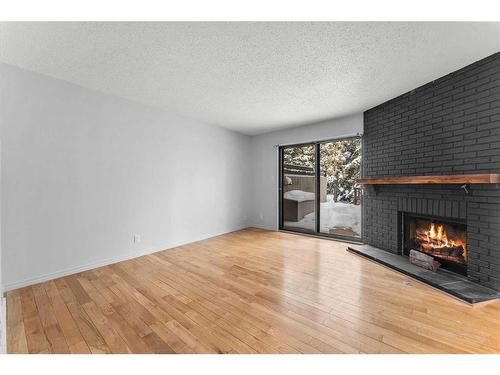 7-2210 Oakmoor Drive Sw, Calgary, AB - Indoor Photo Showing Living Room With Fireplace