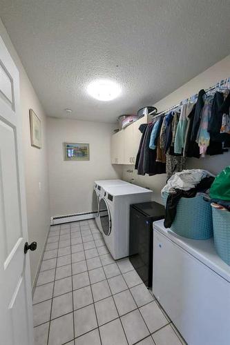 1102 Whitfield Avenue, Crossfield, AB - Indoor Photo Showing Laundry Room