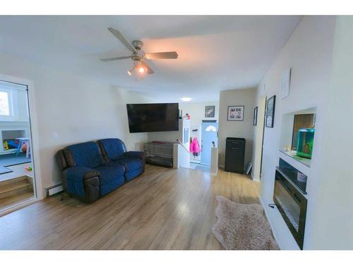 1102 Whitfield Avenue, Crossfield, AB - Indoor Photo Showing Living Room With Fireplace