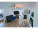 1102 Whitfield Avenue, Crossfield, AB  - Indoor Photo Showing Living Room With Fireplace 