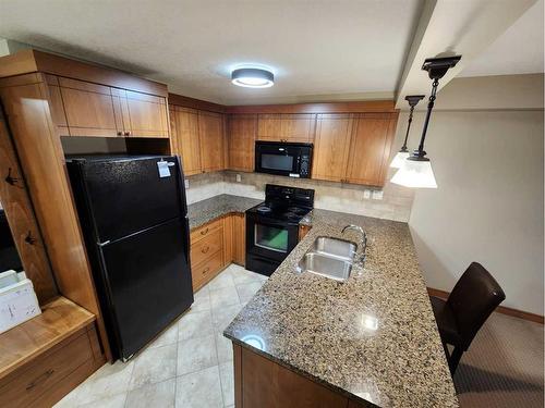 110-315 50 Avenue Sw, Calgary, AB - Indoor Photo Showing Kitchen With Double Sink