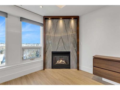 802-600 Princeton Way Sw, Calgary, AB - Indoor Photo Showing Living Room With Fireplace