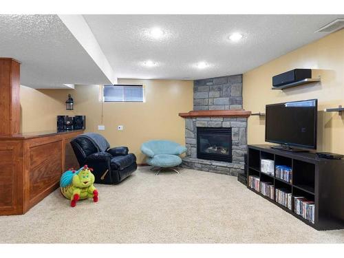 115 Chapala Drive Se, Calgary, AB - Indoor Photo Showing Basement With Fireplace