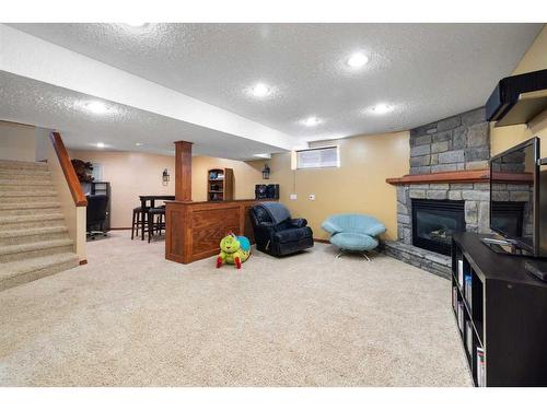 115 Chapala Drive Se, Calgary, AB - Indoor Photo Showing Basement With Fireplace