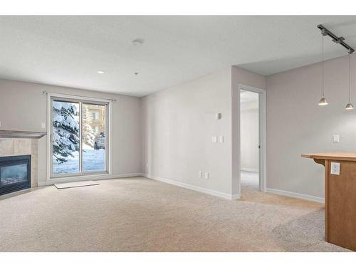 3103-92 Crystal Shores Road, Okotoks, AB - Indoor Photo Showing Living Room With Fireplace