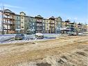 3103-92 Crystal Shores Road, Okotoks, AB  - Outdoor With Balcony With Facade 