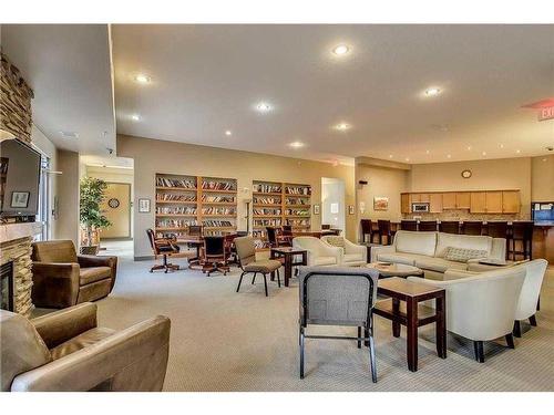 3103-92 Crystal Shores Road, Okotoks, AB - Indoor Photo Showing Living Room With Fireplace