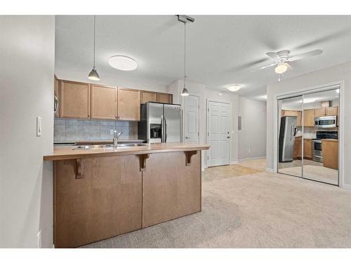 3103-92 Crystal Shores Road, Okotoks, AB - Indoor Photo Showing Kitchen With Double Sink