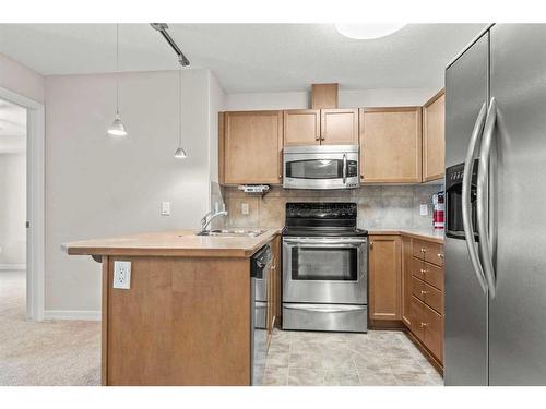 3103-92 Crystal Shores Road, Okotoks, AB - Indoor Photo Showing Kitchen With Stainless Steel Kitchen With Double Sink