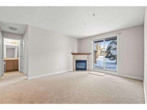 3103-92 Crystal Shores Road, Okotoks, AB - Indoor Photo Showing Living Room With Fireplace