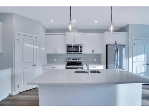 1139 Chinook Winds Circle Sw, Airdrie, AB - Indoor Photo Showing Kitchen With Double Sink With Upgraded Kitchen