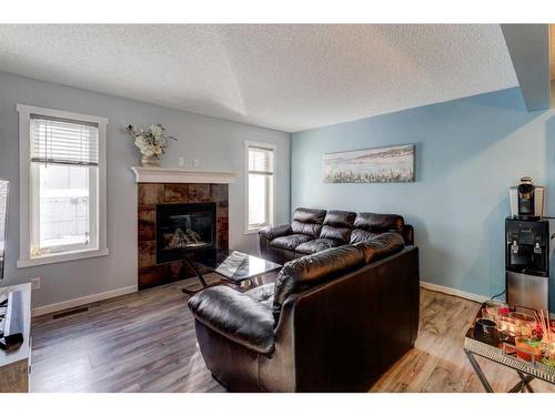 1227 Kings Heights Road Se, Airdrie, AB - Indoor Photo Showing Living Room With Fireplace