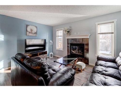 1227 Kings Heights Road Se, Airdrie, AB - Indoor Photo Showing Living Room With Fireplace