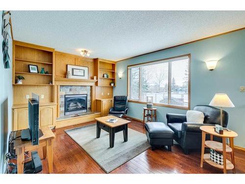 107 Hawkmount Close Nw, Calgary, AB - Indoor Photo Showing Living Room With Fireplace