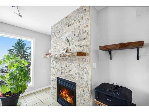 5-200 Hidden Hills Terrace Nw, Calgary, AB - Indoor With Fireplace