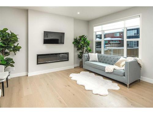 77 Belmont Villas Sw, Calgary, AB - Indoor Photo Showing Living Room With Fireplace