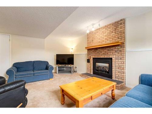 116 Sunvale Crescent Se, Calgary, AB - Indoor Photo Showing Living Room With Fireplace