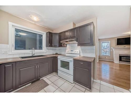 133 38 Avenue Sw, Calgary, AB - Indoor Photo Showing Kitchen With Fireplace