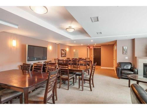 604-920 5 Avenue Sw, Calgary, AB - Indoor Photo Showing Dining Room With Fireplace