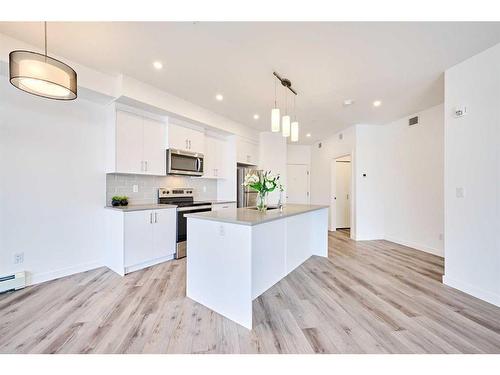 307-205 Spring Creek Common Sw, Calgary, AB - Indoor Photo Showing Kitchen With Upgraded Kitchen