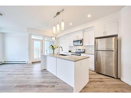 307-205 Spring Creek Common Sw, Calgary, AB - Indoor Photo Showing Kitchen With Upgraded Kitchen