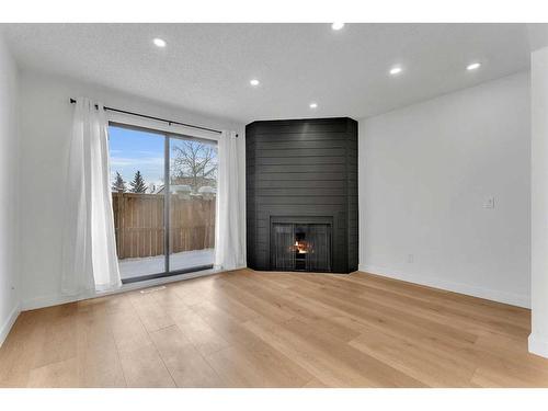 87-2511 38 Street Ne, Calgary, AB - Indoor Photo Showing Other Room With Fireplace