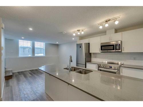 426 Cranbrook Square Se, Calgary, AB - Indoor Photo Showing Kitchen With Double Sink With Upgraded Kitchen