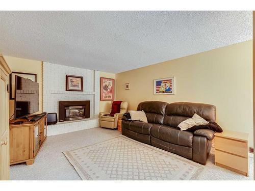 127 Bracewood Road Sw, Calgary, AB - Indoor Photo Showing Living Room With Fireplace