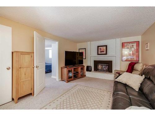 127 Bracewood Road Sw, Calgary, AB - Indoor Photo Showing Living Room With Fireplace